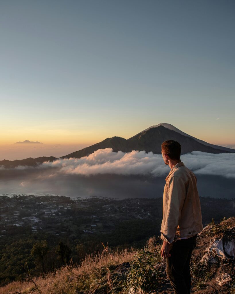 A Man Standing on the Mountain Summit