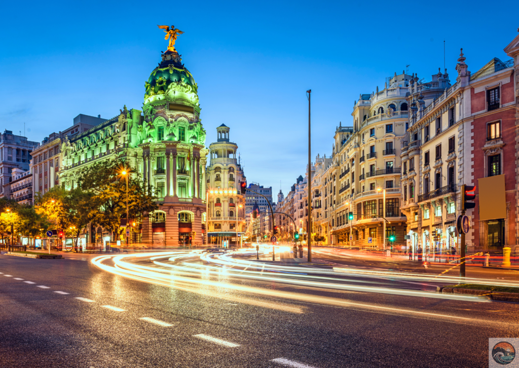 a street with a large building and a statue on top