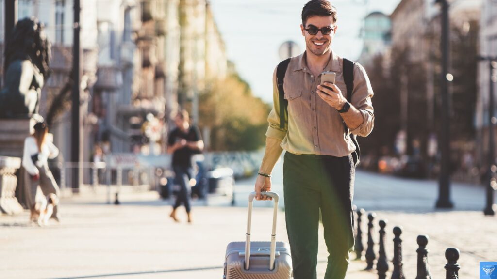 a man walking with a suitcase and phone