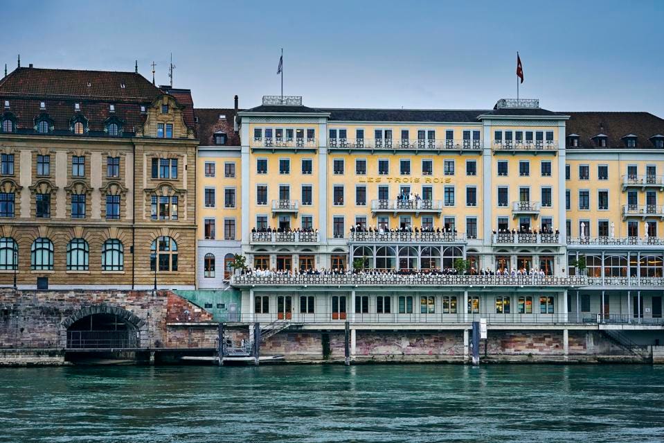 a building with many windows and a bridge over water